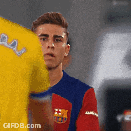 Man In Barcelona Jersey Next To Man In Yellow Shirt GIF