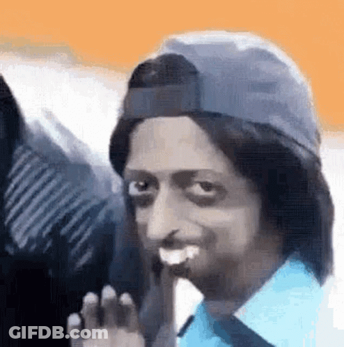 Man In Baseball Cap And Blue Shirt Smiling And Waving GIF