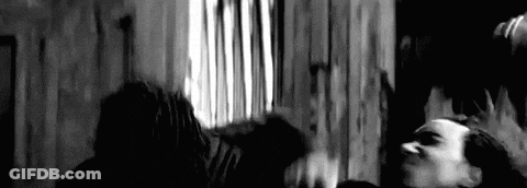 Man In Baseball Cap And Jacket Standing Before Wall GIF