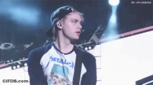 Man In Baseball Cap And Metallica Shirt On Stage GIF
