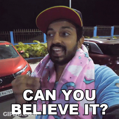 Man In Baseball Cap And Pink Scarf Says Can You Believe It GIF