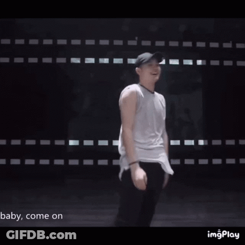 Man In Baseball Cap And Sunglasses In Front Of Wall Saying Baby Come On GIF