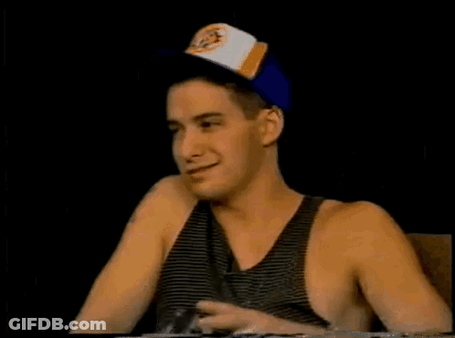 Man In Baseball Cap And Tank Top Pointing Up GIF