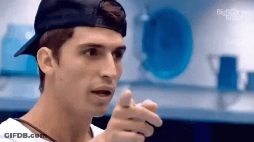 Man In Baseball Cap And White Shirt Pointing GIF