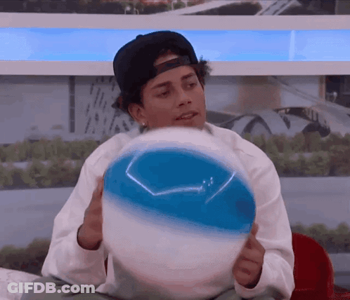 Man In Baseball Cap Holding Beach Ball GIF