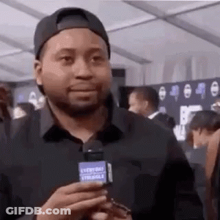 Man In Baseball Cap Holding Microphone GIF