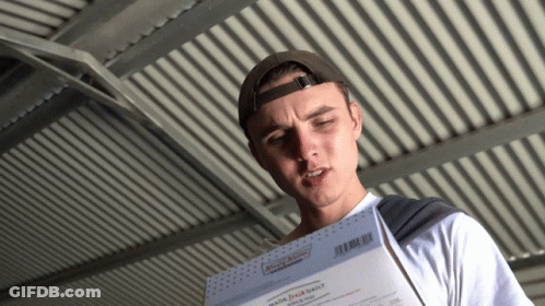 Man In Baseball Cap Holding Paper Saying Made Fresh Daily GIF