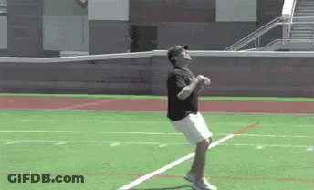 Man In Baseball Cap Jumping On Field GIF
