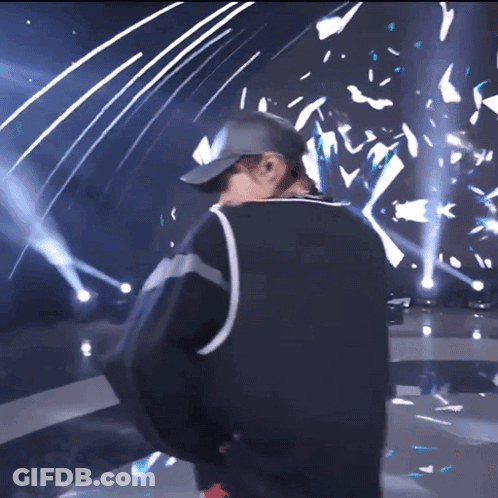 Man In Baseball Cap On Stage GIF