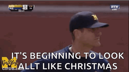 Man In Baseball Cap Saying It's Beginning To Look Like Christmas GIF