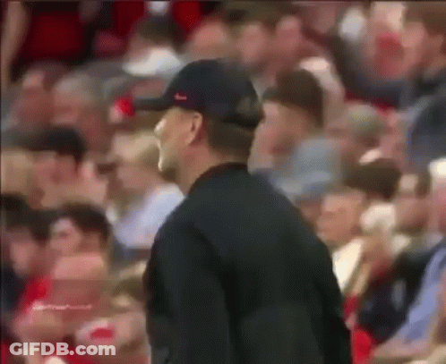 Man In Baseball Cap Standing Before Crowd GIF