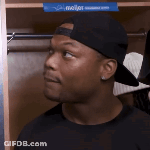 Man In Baseball Cap Standing In Locker With Meijer Advertisement GIF