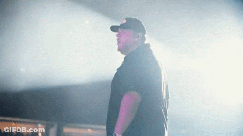 Man In Baseball Cap Standing On Stage GIF
