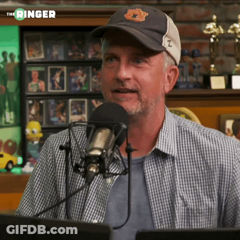 Man In Baseball Cap Talking Into Microphone GIF