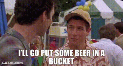 Man In Baseball Cap Talking To Another At Carnival GIF