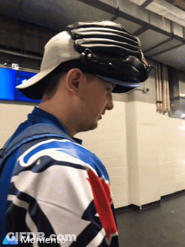 Man In Baseball Cap With Momento Logo Shirt GIF