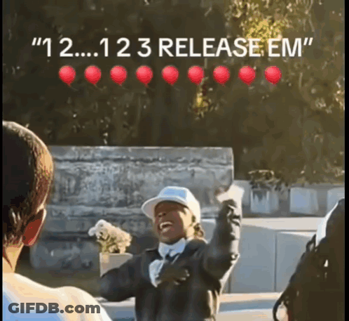 Man In Baseball Cap With Red Balloons Saying 123 Release Em GIF