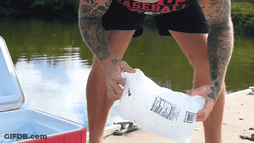 Man In Baseball Shirt Holding Bag Of Ice GIF