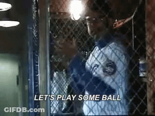 Man In Baseball Uniform Behind Fence Saying Let's Play Some Ball GIF