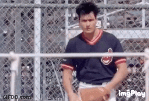 Man In Baseball Uniform Holding Baseball At Fence GIF