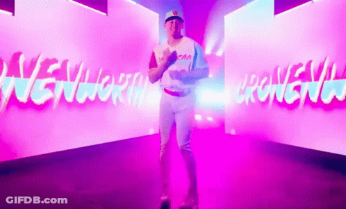 Man In Baseball Uniform In Front Of New York Wall GIF