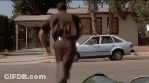 Man In Baseball Uniform Number 23 Running Down Street GIF