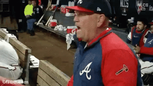 Man In Baseball Uniform Sitting In Dugout GIF