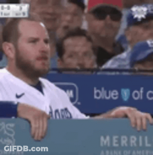 Man In Baseball Uniform Sitting In Dugout GIF