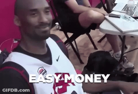 Man In Basketball Jersey At Table With Easy Money GIF