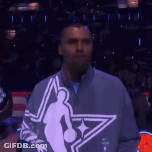 Man In Basketball Player Sweatshirt In Front Of Crowd GIF