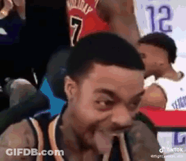 Man In Basketball Uniform Making Funny Face Sitting In Chair GIF