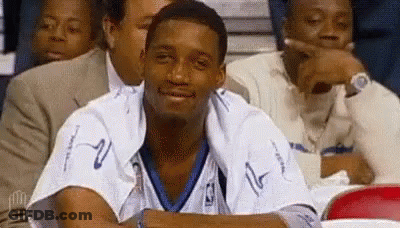 Man In Basketball Uniform Sitting In Stadium GIF
