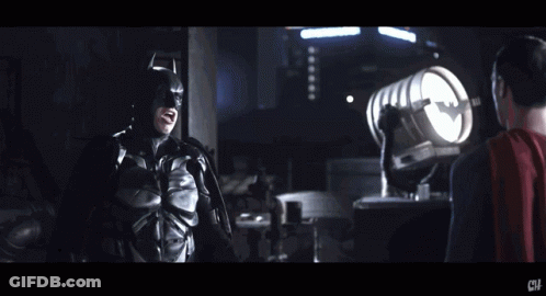 Man In Bat Suit Standing Next To Man In Red Cape Saying Now I'm A Bat GIF