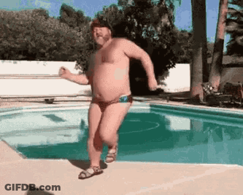 Man In Bathing Suit Running By Pool GIF