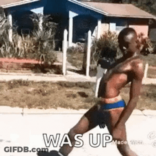 Man In Bathing Suit Walking Down Street GIF