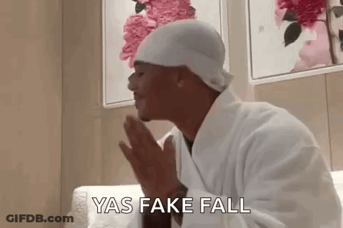 Man In Bathrobe And Hat Praying On Couch GIF