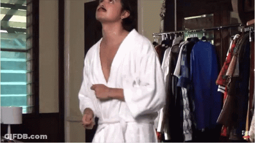 Man In Bathrobe In Front Of Closet GIF
