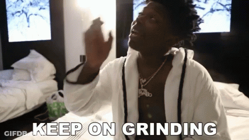 Man In Bathrobe Sitting On Bed Saying Keep On Grinding GIF