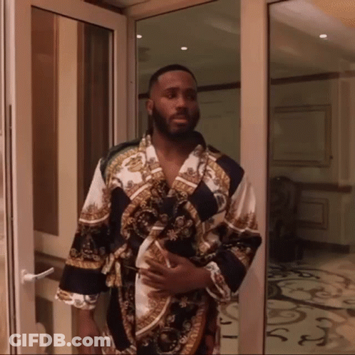 Man In Bathrobe Standing In Doorway GIF