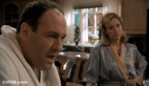 Man In Bathrobe Talking To Woman In Robe GIF