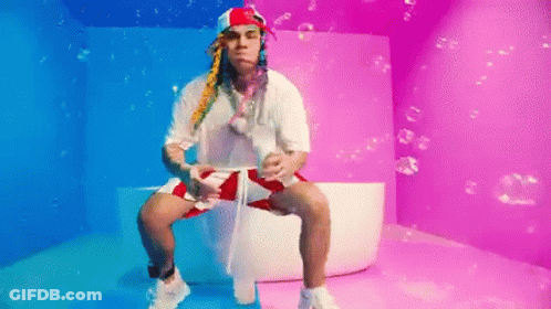 Man In Bathtub With Bubbles In Colorful Room GIF