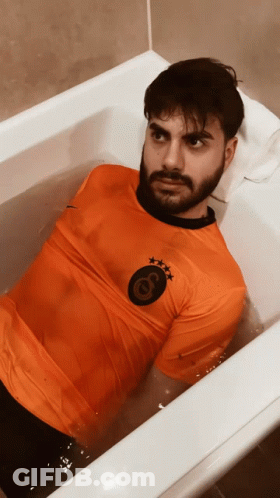 Man In Bathtub With Orange Shirt Letter G GIF