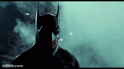 Man In Batman Costume Close Up Dark Room GIF