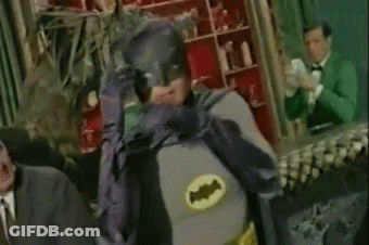 Man In Batman Costume Hands On Face GIF