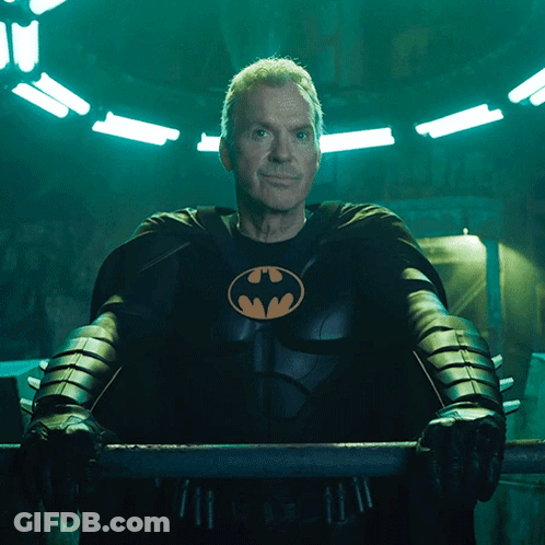 Man In Batman Costume Holding Bar GIF