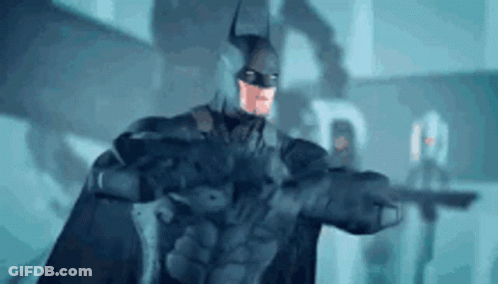 Man In Batman Costume Holding Gun GIF