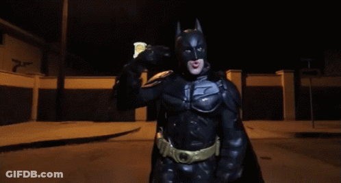 Man In Batman Costume Holding Soda Can GIF