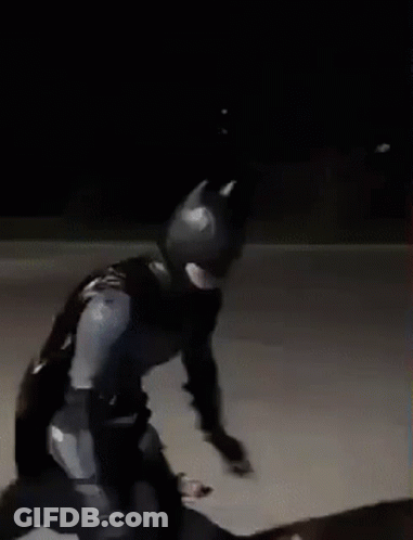 Man In Batman Costume Skateboarding At Night GIF