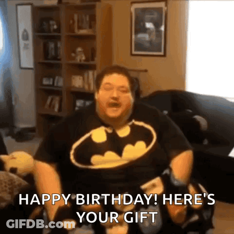 Man In Batman Shirt Holding Game Controller On Couch GIF