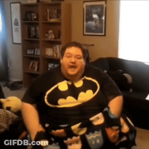 Man In Batman Shirt Sitting GIF